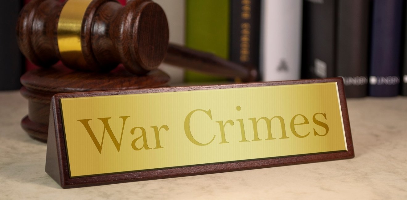 image of plaque reading "War Crimes" with gavel