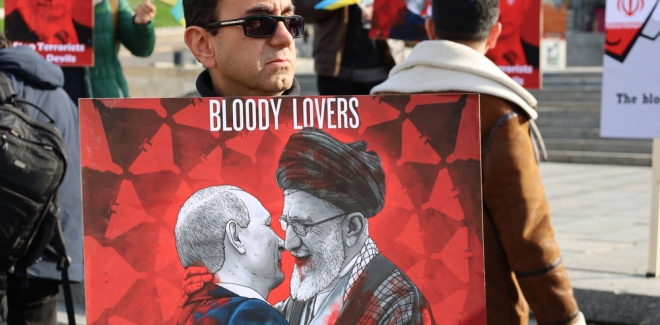 Kyiv, Ukraine - 28 October 2022: Iranian man with political banner in hands protests against dictatorship and ayatollah regime in Iran at street rally. reportage editorial photo