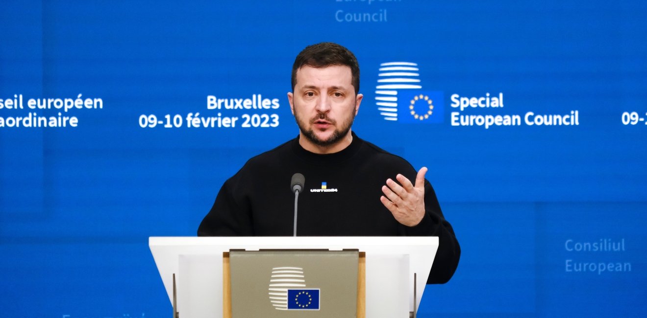 Zelensky speaking at a podium 