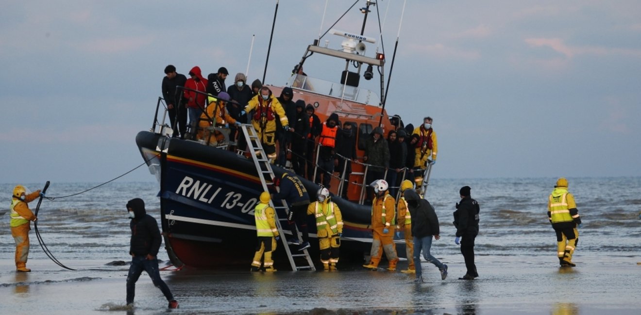 Migrants brought ashore after being rescued at sea by RNLI after travelling across the English Channel. 