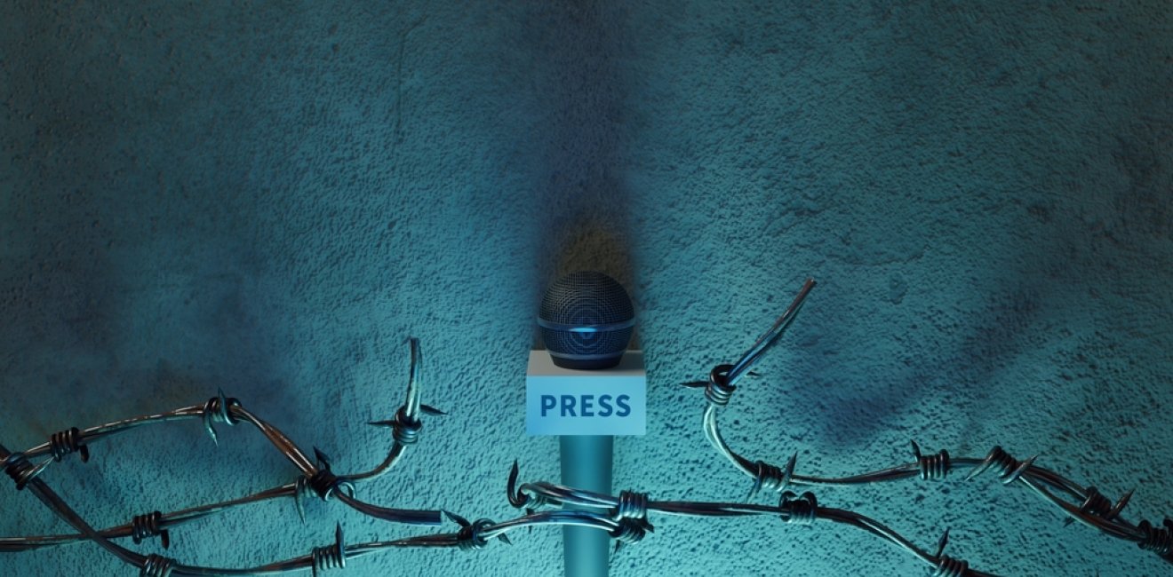 Microphone held by barbed wire