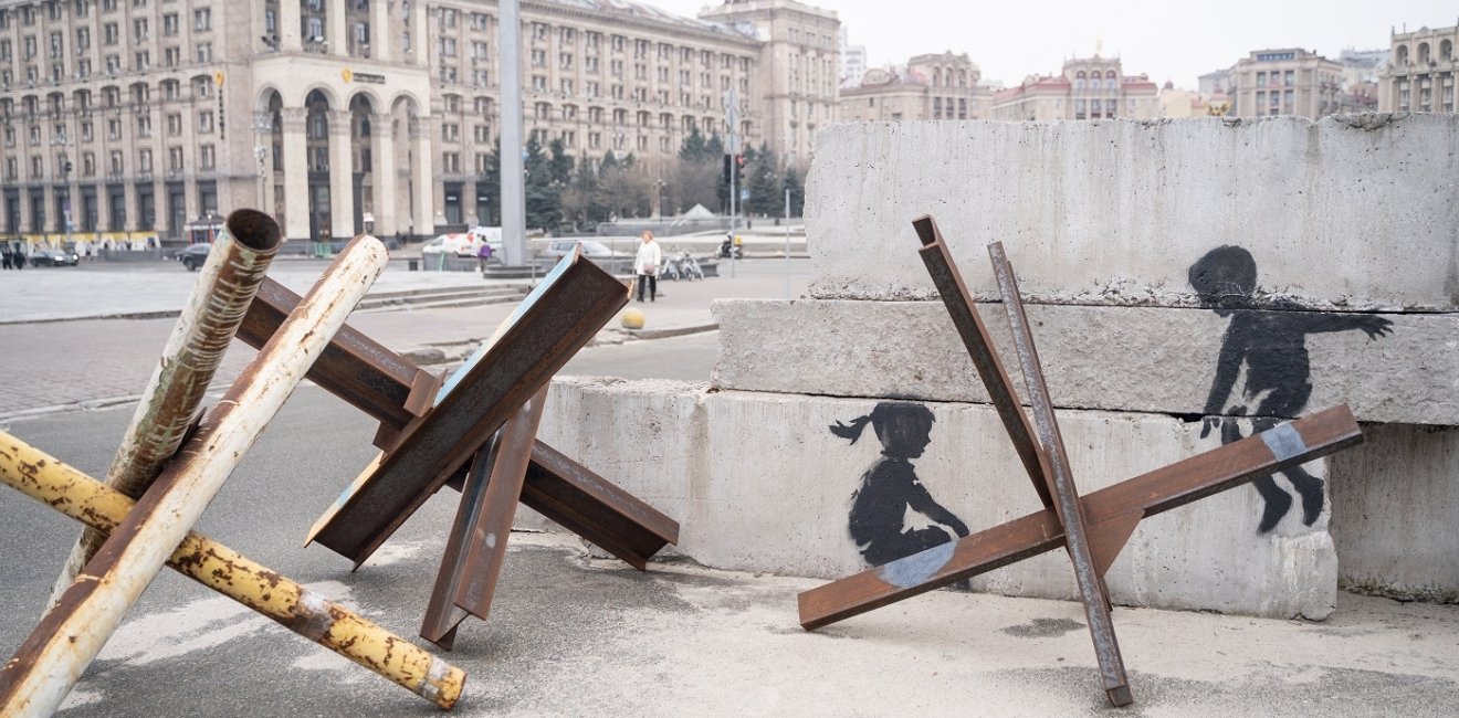 Czech Hedgehogs with street art making it look like children on a seesaw