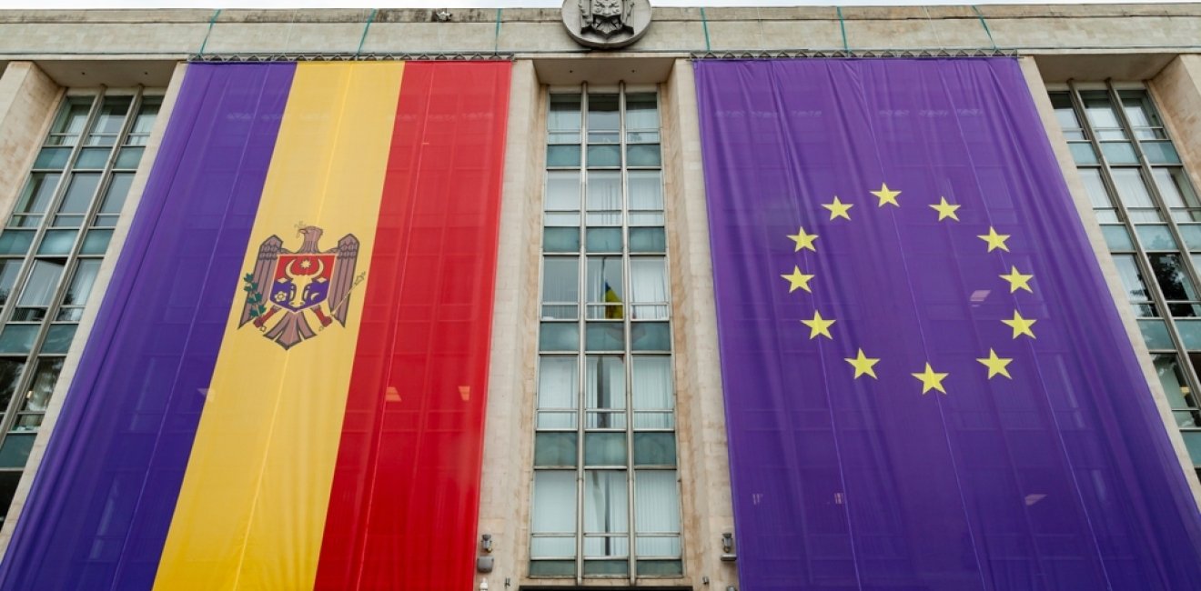 Large flags of Moldova and the European Union on the building of the government of Moldova on the eve of the summit of the European Political Community