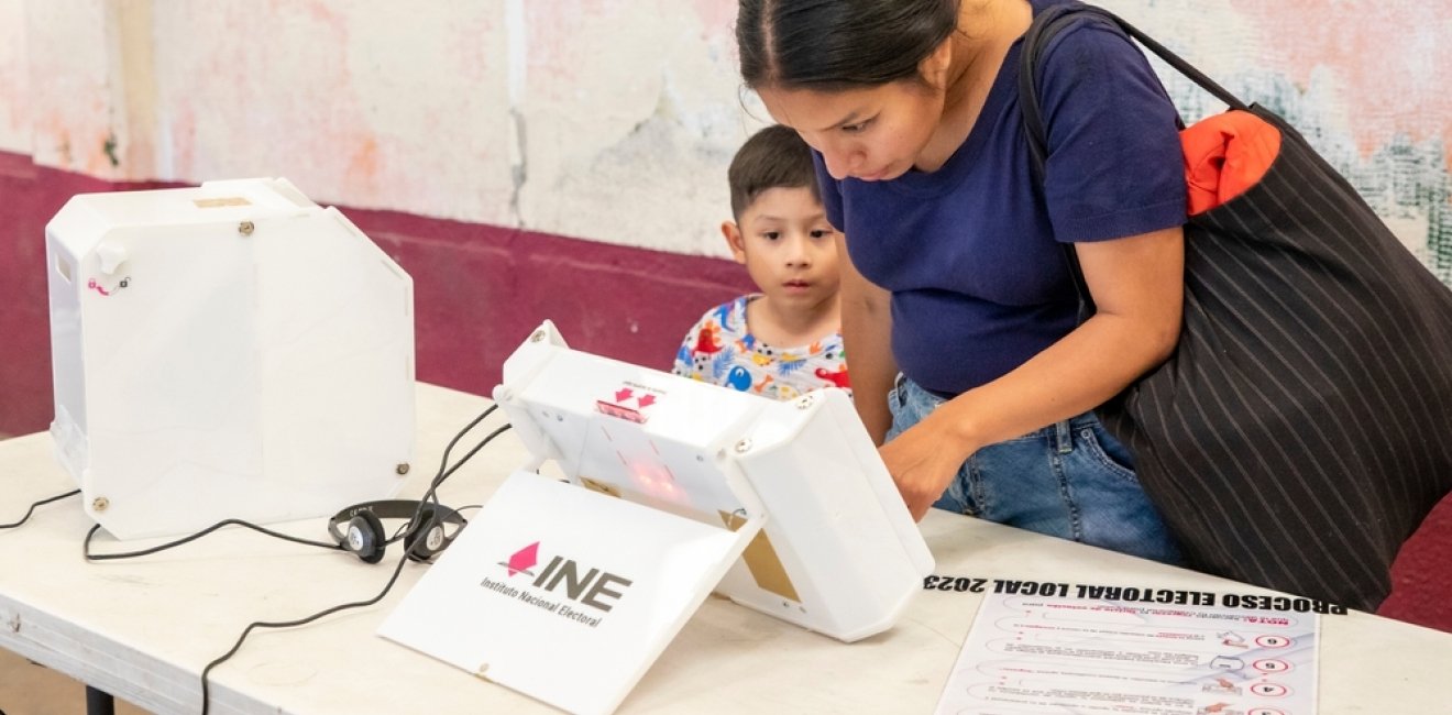  A woman casting her vote for State of Mexico's Governor using a new electronic ballot box system.