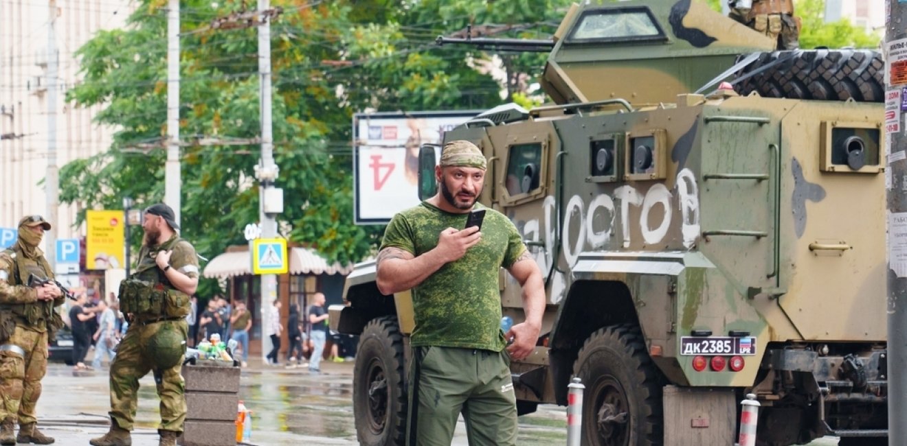 Man next to tank in city street