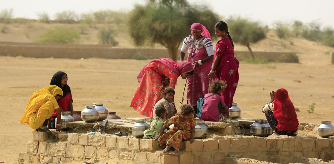 Women drawing water from a well