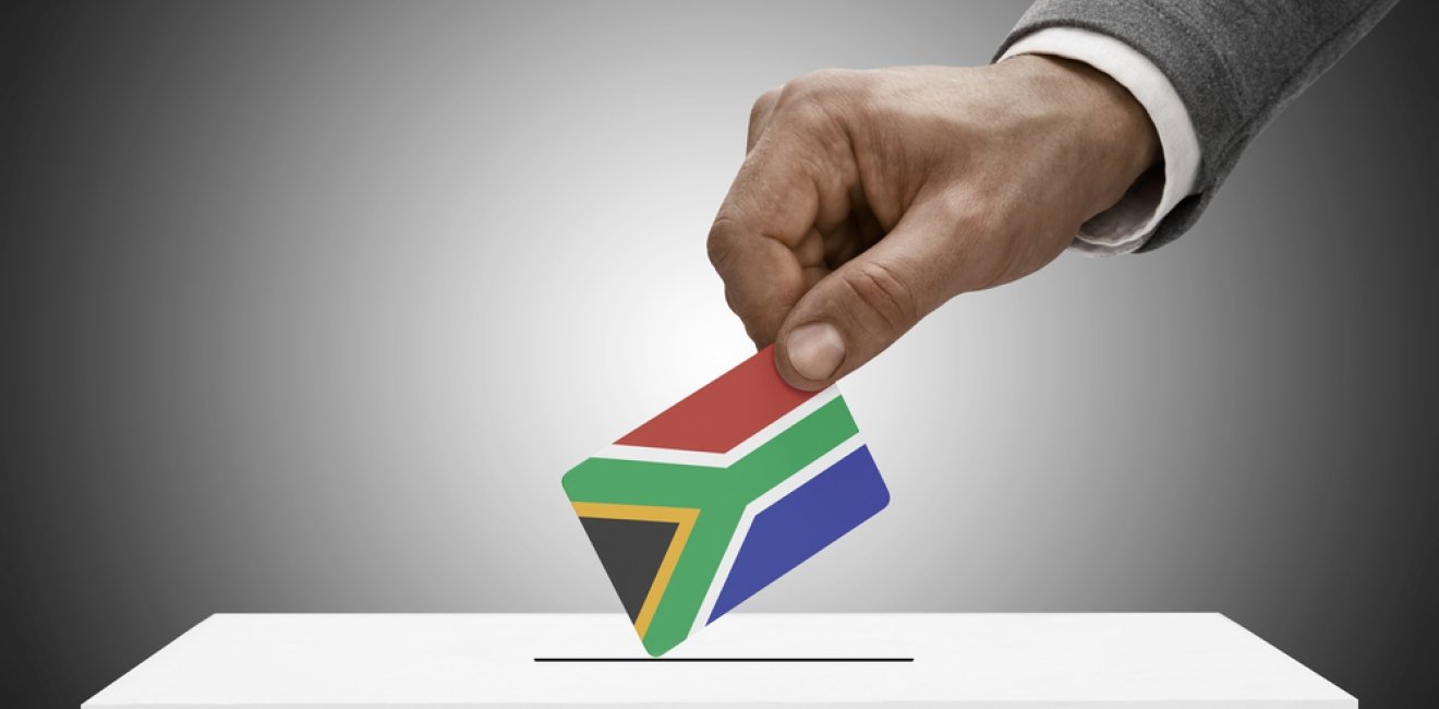 Man Casting Ballot with South Africa Flag