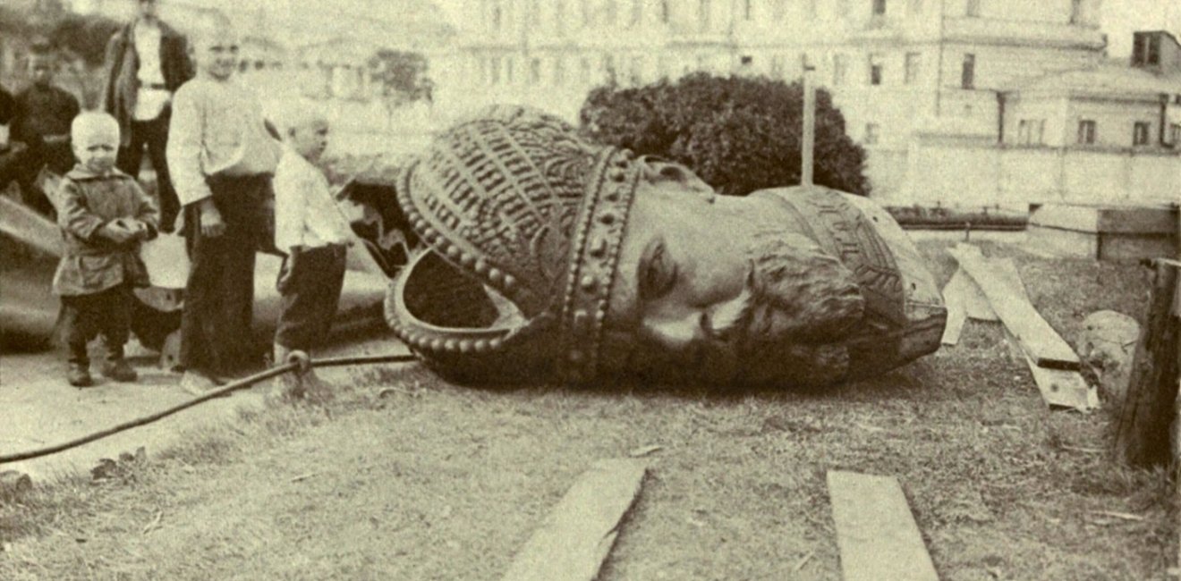 Historical photo of a toppled statue 