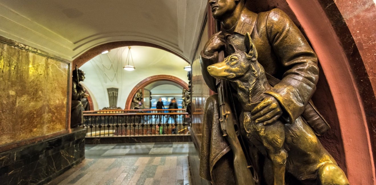 A Soviet border guard and his dog (1938) at the Revolution Square subway station in Moscow.