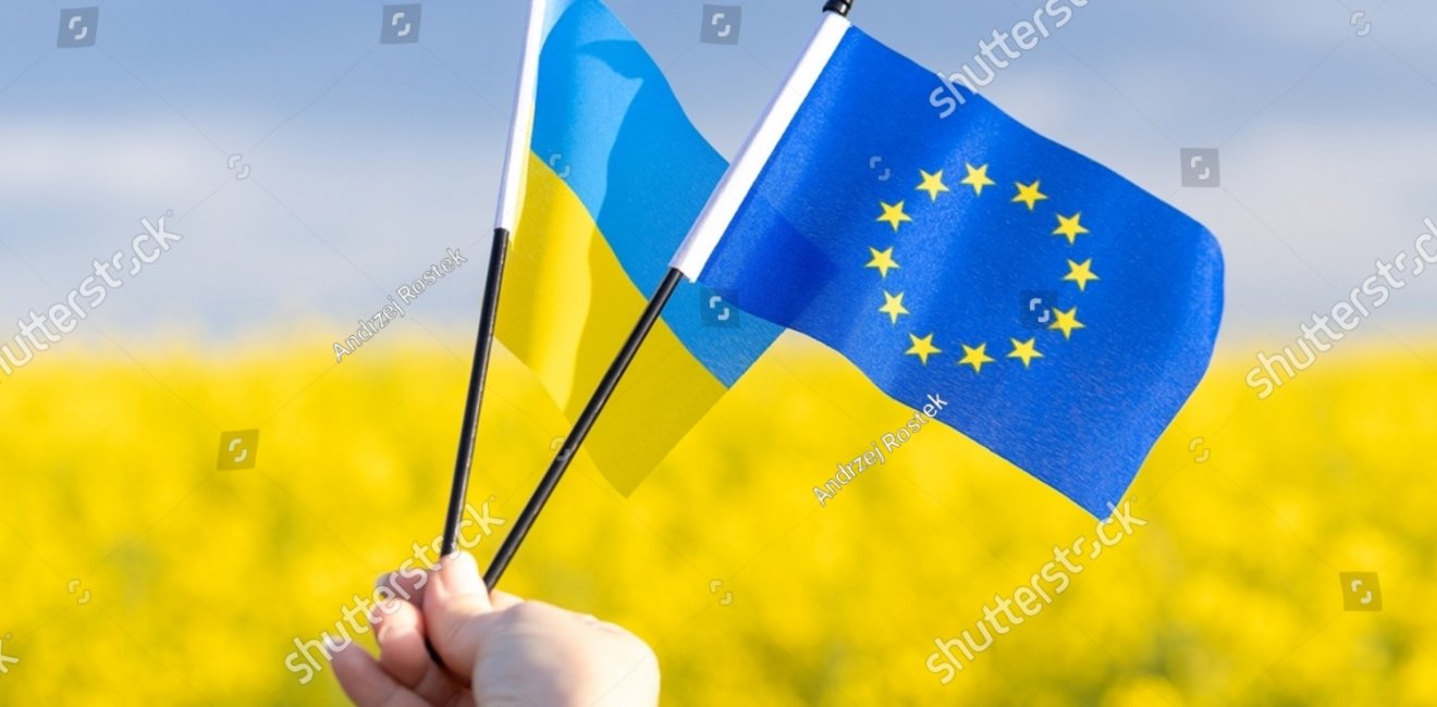 Flags with symbols of the European Union and Ukraine held in a girl's hand, Concept, Acceptance of the Ukrainian candidacy to apply for EU membership