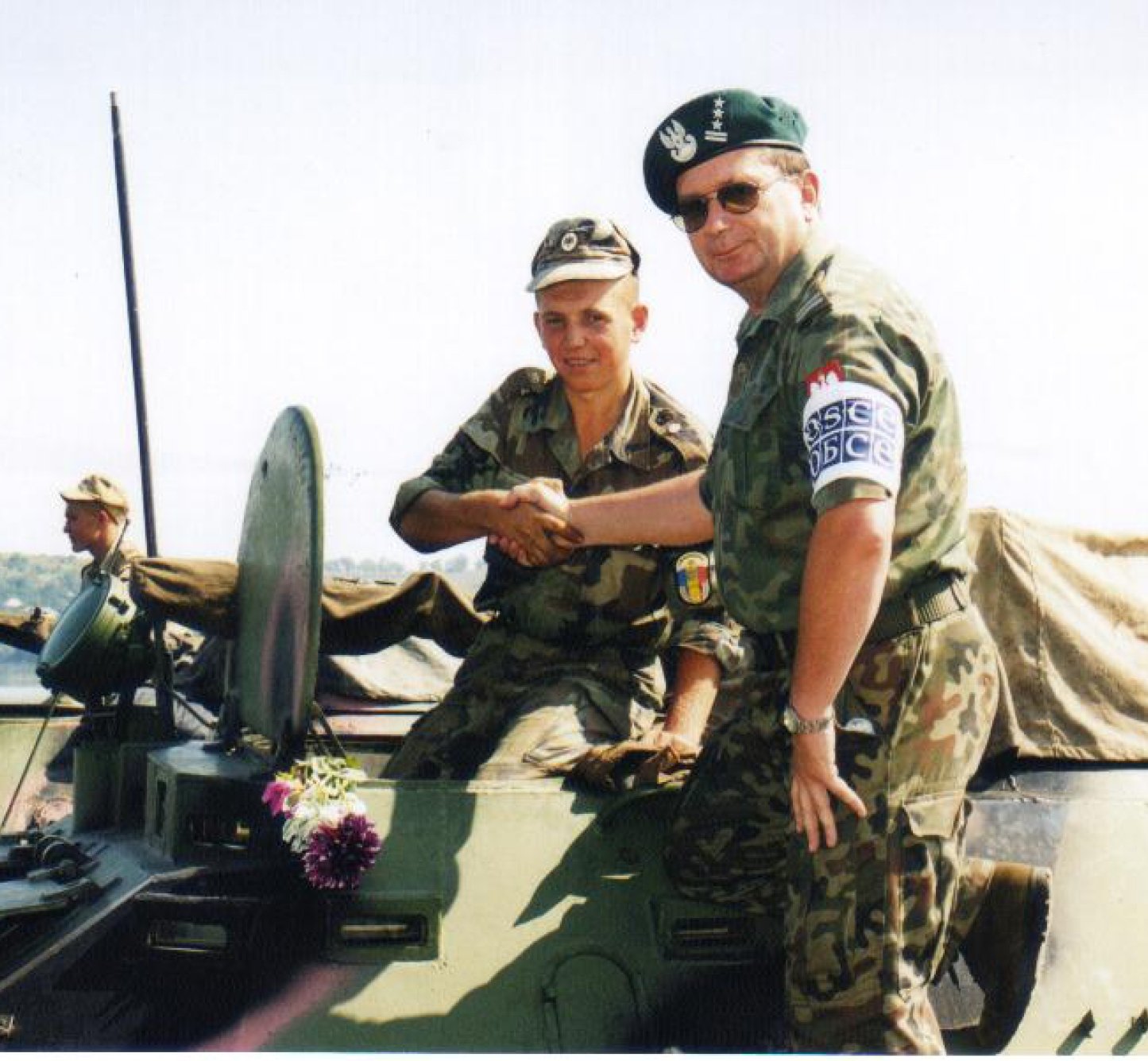 Col. Jan Nadolski, military mission member of the OSCE Mission to Moldova, congratulates a young Moldovan conscript on the withdrawal from the security zone as they prepare to cross the river Dniestr, 14 August 2003.