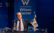 David Sanger holding up a newspaper 