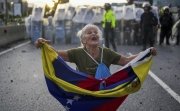 Protesters demonstrate against the official election results declaring President Nicolas Maduro's reelection in Valencia, Venezuela, Monday, July 29, 2024, the day after the vote.