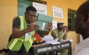 A man has his photo taken by an electoral worker before voting during the presidential elections in Yola, Nigeria, Saturday, February 25, 2023.