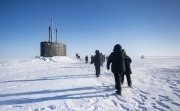 Chief of Naval Operations Adm. Lisa Franchetti walks with other distinguished visitor towards the Virginia-class fast-attack submarine USS Indiana (SSN 789) before embarking Indiana during Operation Ice Camp (ICE CAMP) 2024.