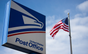 US Post Office Sign With American Flag in the Background