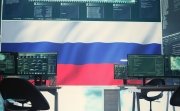 Governmental cyber operations room with Russian flag on big screen, focusing on information war and trolling. Highlighting the role of hackers in spreading