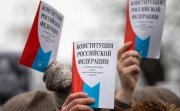 Opposition supporters hold a copy of Russia's constitution during a rally against constitutional reforms proposed by President Vladimir Putin in central Moscow.