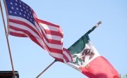 Mexican tricolor and American flag waving on wind.