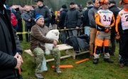 President Lukashenko sitting with a small white dog among a crowd of people 