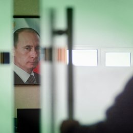 Image of Vladimir Putin behind closing door