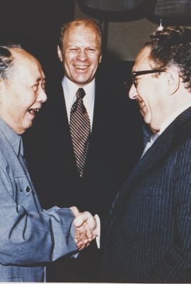 President Ford and daughter Susan watch as Secretary of State Henry Kissinger shakes hands with Mao Tse-Tung; Chairman of Chinese Communist Party, during a visit to the Chairman’s residence.  