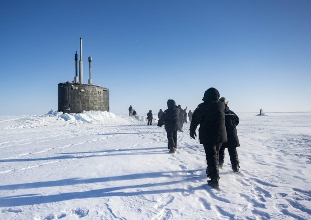 Chief of Naval Operations Adm. Lisa Franchetti walks with other distinguished visitor towards the Virginia-class fast-attack submarine USS Indiana (SSN 789) before embarking Indiana during Operation Ice Camp (ICE CAMP) 2024.