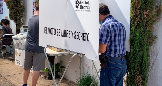 Zapopan, Jalisco, Mexico; June 6 2021: Mexican legislative election 2021. Hispanic adult male casting vote inside polling station. District 4. Electoral Federal Institute. Your vote is free and secret