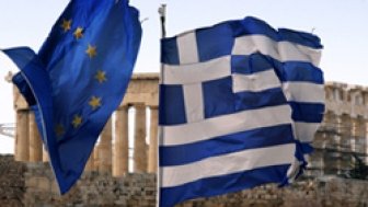 A Greek and an EU flag fly over the Greek ministry of finance in Athens