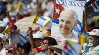 Catholic faithful cheer during the arrival of Pope Francis (not pictured) who will hold Mass in Holguin, Cuba, September 21, 2015