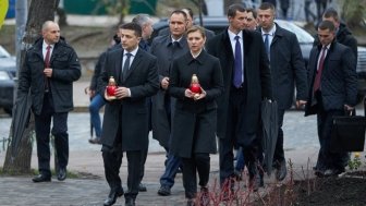 Ukrainian President Volodymyr Zelenskyy and his wife, Olena Zalenska, hold candles as they walk to a memorial in Independence Square in Kyiv, Ukraine. Source: President.gov.ua