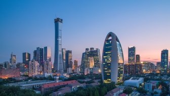 A photo of the Beijing skyline at dusk.