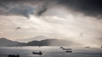 Container ships in the ocean at sunset.