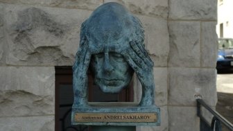 Bust of man holding head in hands