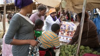 woman explain cervical cancer in market 