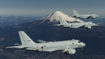 Three JMSDF planes in flight with Mount Fuji in the background.