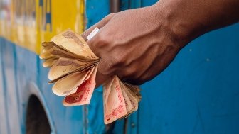 Man holding Indian Rupee notes