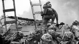 A soldier climbs over the seawall during the Inchon Landing in 1950.