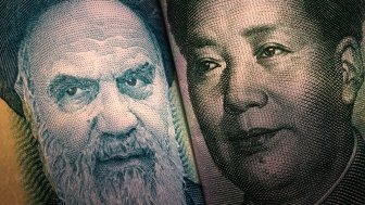 A very close shot showing details of the currency of Iran and China.