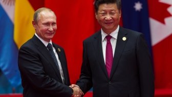 A picture of Xi Jinping and Vladimir Putin shaking hands.