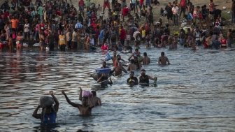 Migrants Wading Across the Rio Grande