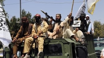 Taliban fighters celebrate the third anniversary of the withdrawal of US-led troops from Afghanistan, in Kabul, Afghanistan, Wednesday, Aug. 14, 2024. (AP Photo/Siddiqullah Alizai)