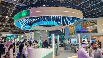 Visitors walking through DEWA Dubai Electricity and water Authority pavilion at 43rd GITEX Global 2023, largest tech and startup event in the world in Dubai, United Arab Emirates - O