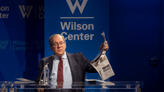 David Sanger holding up a newspaper 