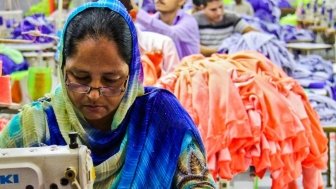 A woman worker manufactures a garment in a project benificiary factory - women constuitute a significant portion of the workforce in Pakistan's garment industry