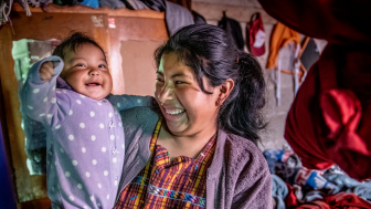 Health workers visiting Veronica, her twins, Ashley Veronica ( purple dot outfit) and Stephanie Daniella (little hearts outfit), son and husband