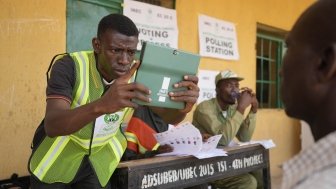 A man has his photo taken by an electoral worker before voting during the presidential elections in Yola, Nigeria, Saturday, February 25, 2023.