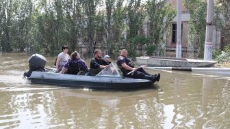 Group on boat in flooded area