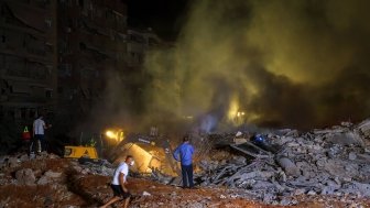 27 September 2024, Lebanon, Beirut: Rescue workers gather at the site of a massive Israeli air attack on pro-Iranian Hezbollah headquarters in the southern suburbs of Beirut