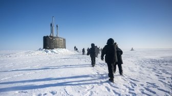 Chief of Naval Operations Adm. Lisa Franchetti walks with other distinguished visitor towards the Virginia-class fast-attack submarine USS Indiana (SSN 789) before embarking Indiana during Operation Ice Camp (ICE CAMP) 2024.